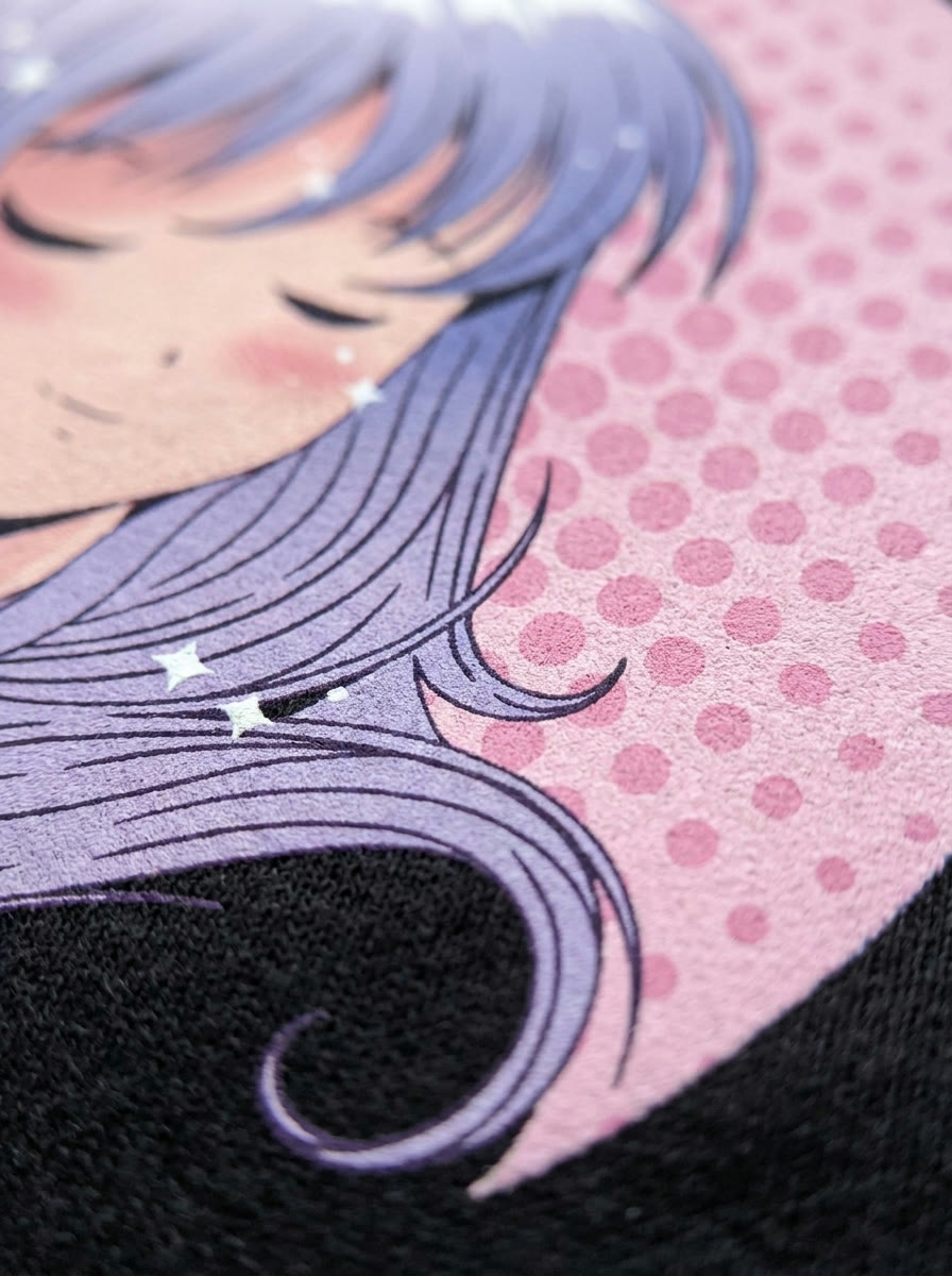 Macro detail of the anime girl print showing the ink on the cotton weave and the pink halftone dots